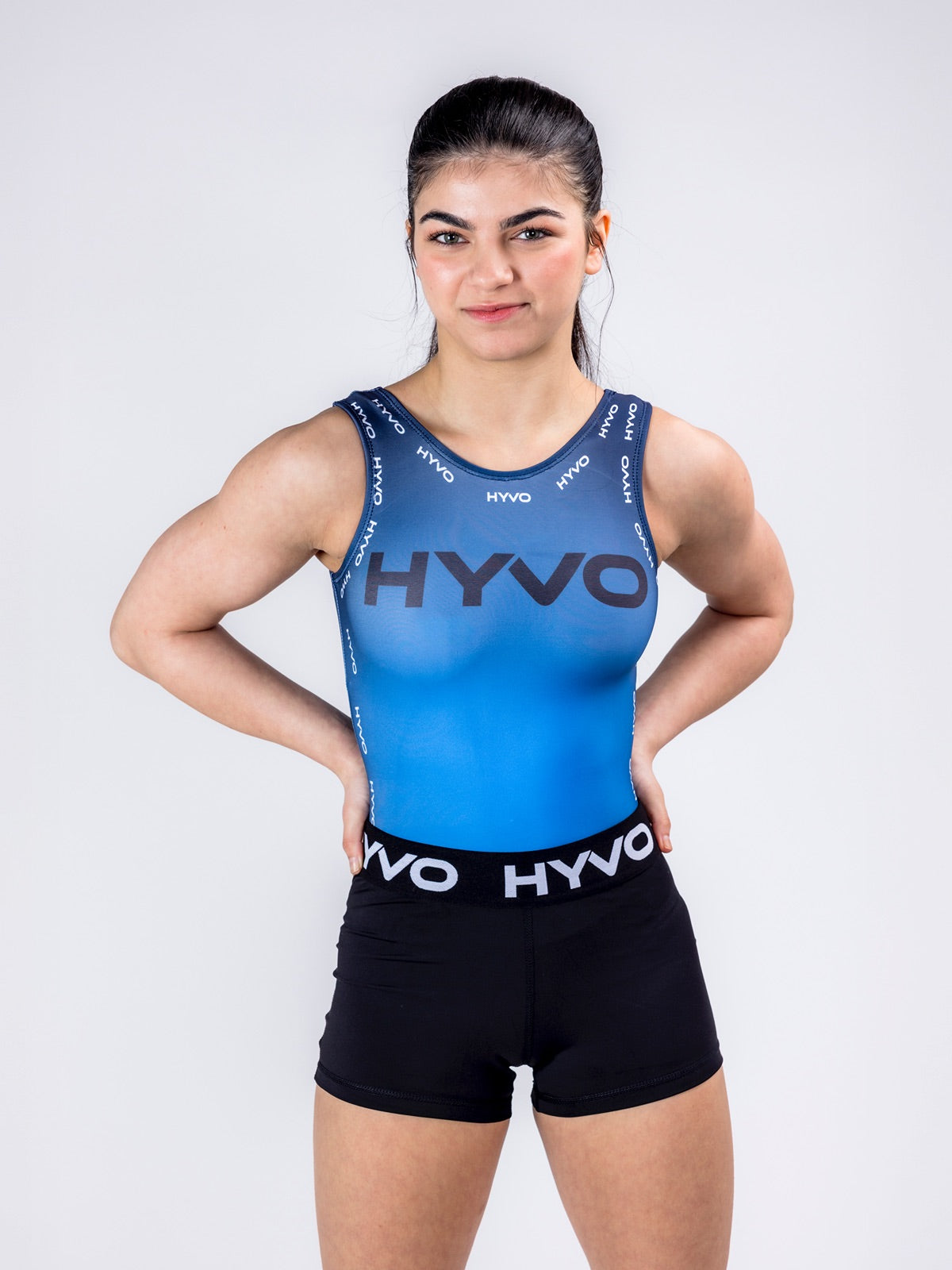 Front view of night blue girls gymnastics leotard from the HYVO Rise Up range styled with black gymnastics shorts
