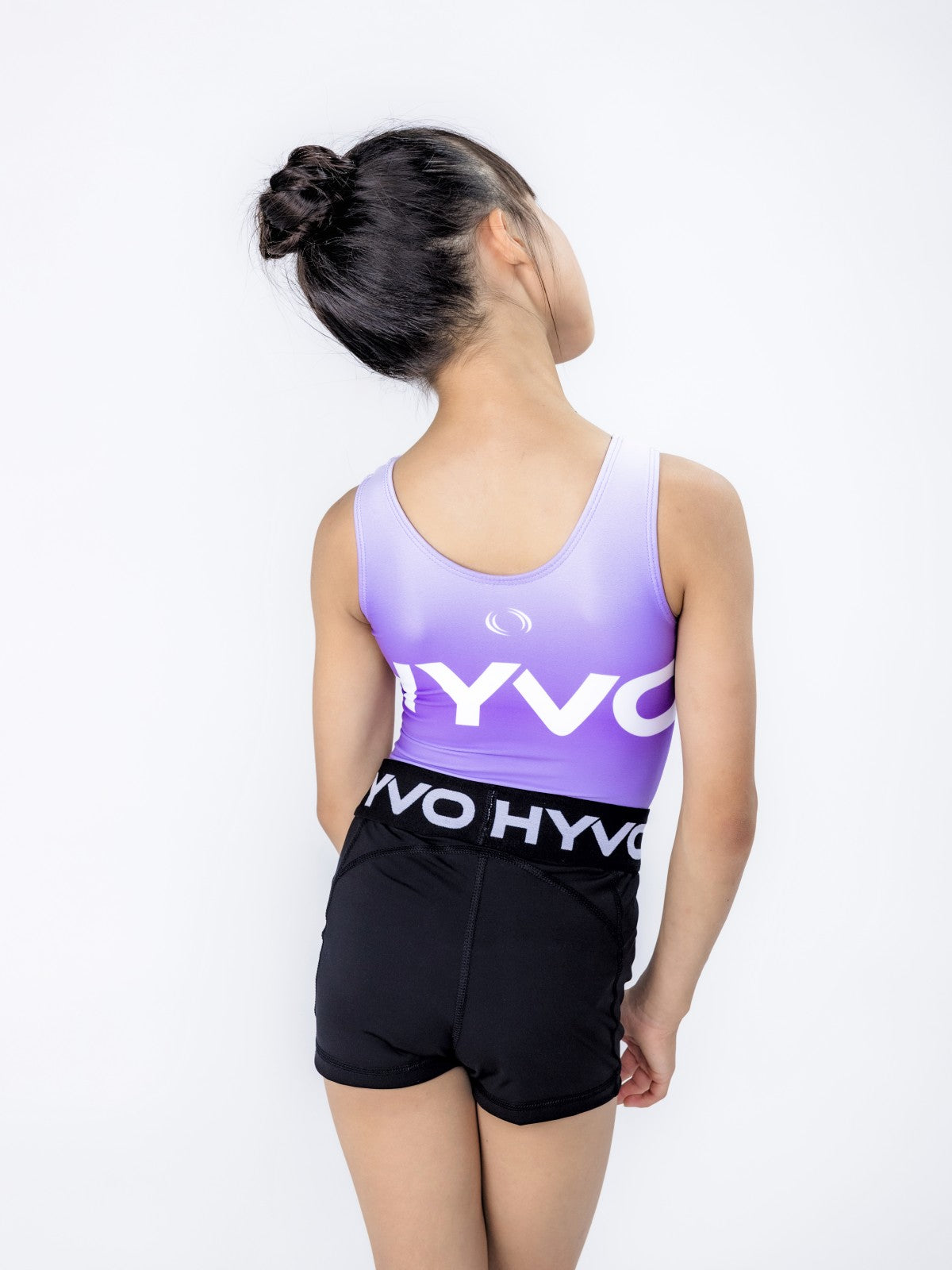 Back view of playful purple girls gymnastics leotard from the HYVO Ascend range styled with gymnastics shorts