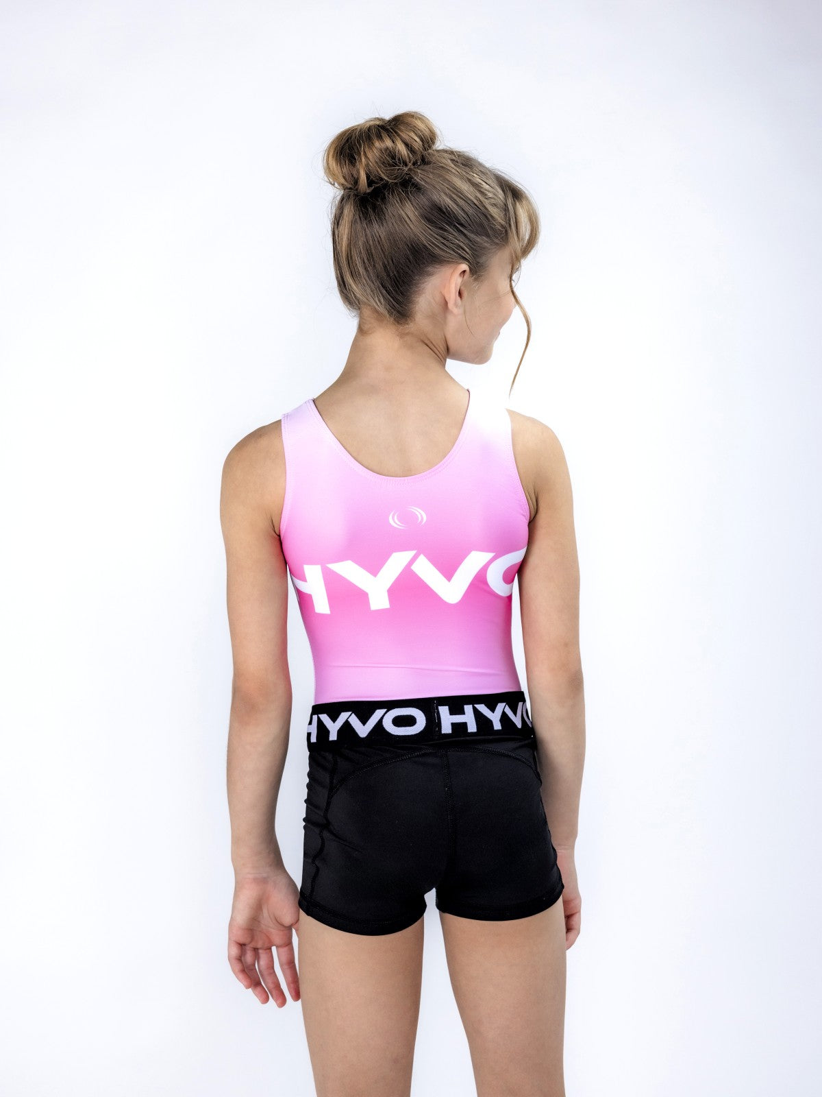 Back view of pretty pink girls gymnastics leotard from the HYVO Ascend range styled with gymnastics shorts
